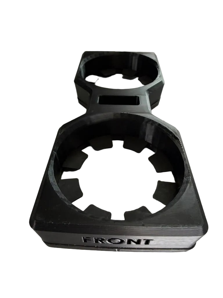 A black plastic cup holder insert for a vehicle, shown on a plain off-white background. The front of the insert is labeled 'FRONT' and features a textured, rugged design with circular cutouts.