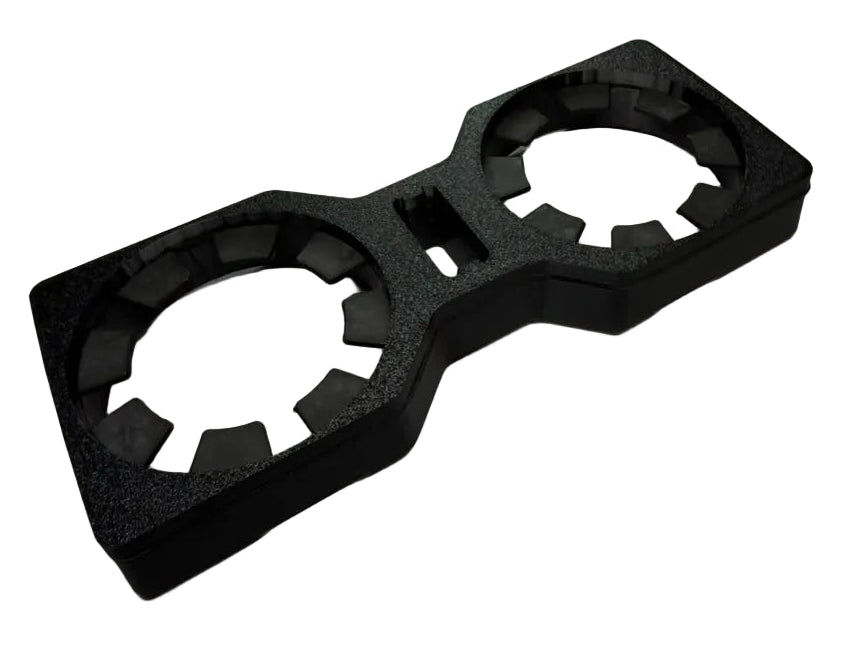 A black textured foam double cup holder insert, shown from an elevated perspective on a light gray background.