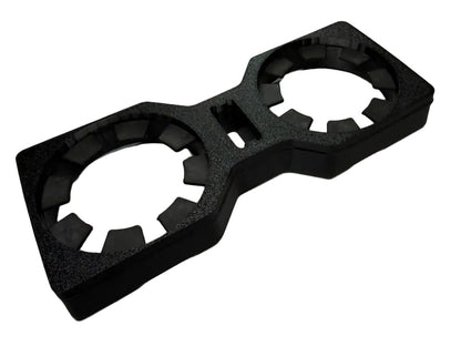 A black textured foam double cup holder insert, shown from an elevated perspective on a light gray background.