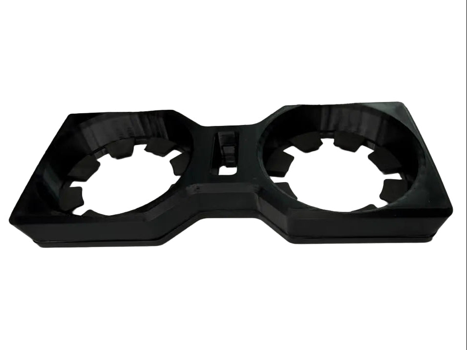 A black plastic dual cup holder insert with a 3D-printed look, shown on a white background.