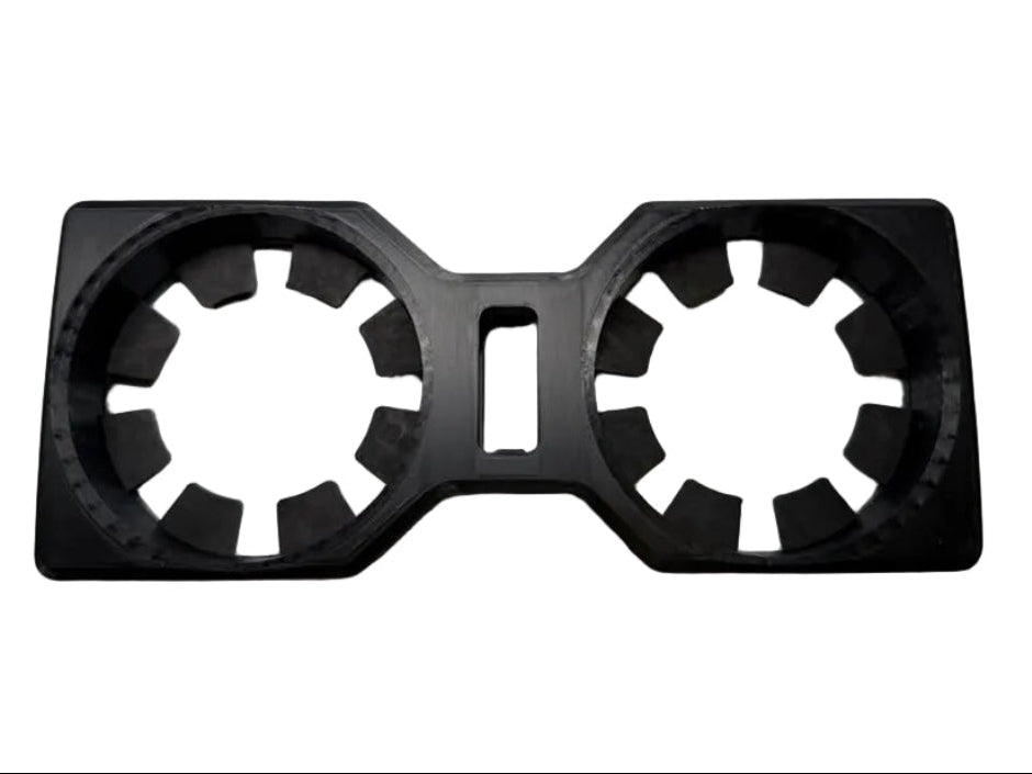 A black plastic dual cup holder insert with a central cutout, shown on a plain white background.
