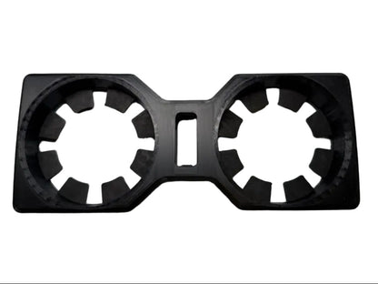 A black plastic dual cup holder insert with a central cutout, shown on a plain white background.