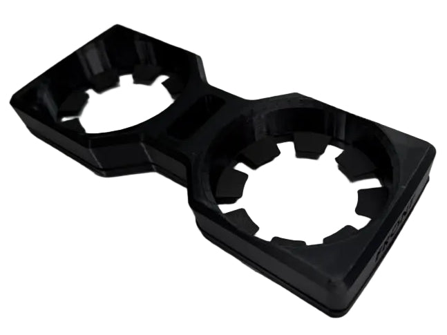 A black plastic dual cup holder insert with a hexagonal design, shown on a light gray background.