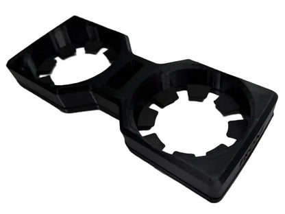 A black plastic dual cup holder insert with a hexagonal design, shown on a light gray background.
